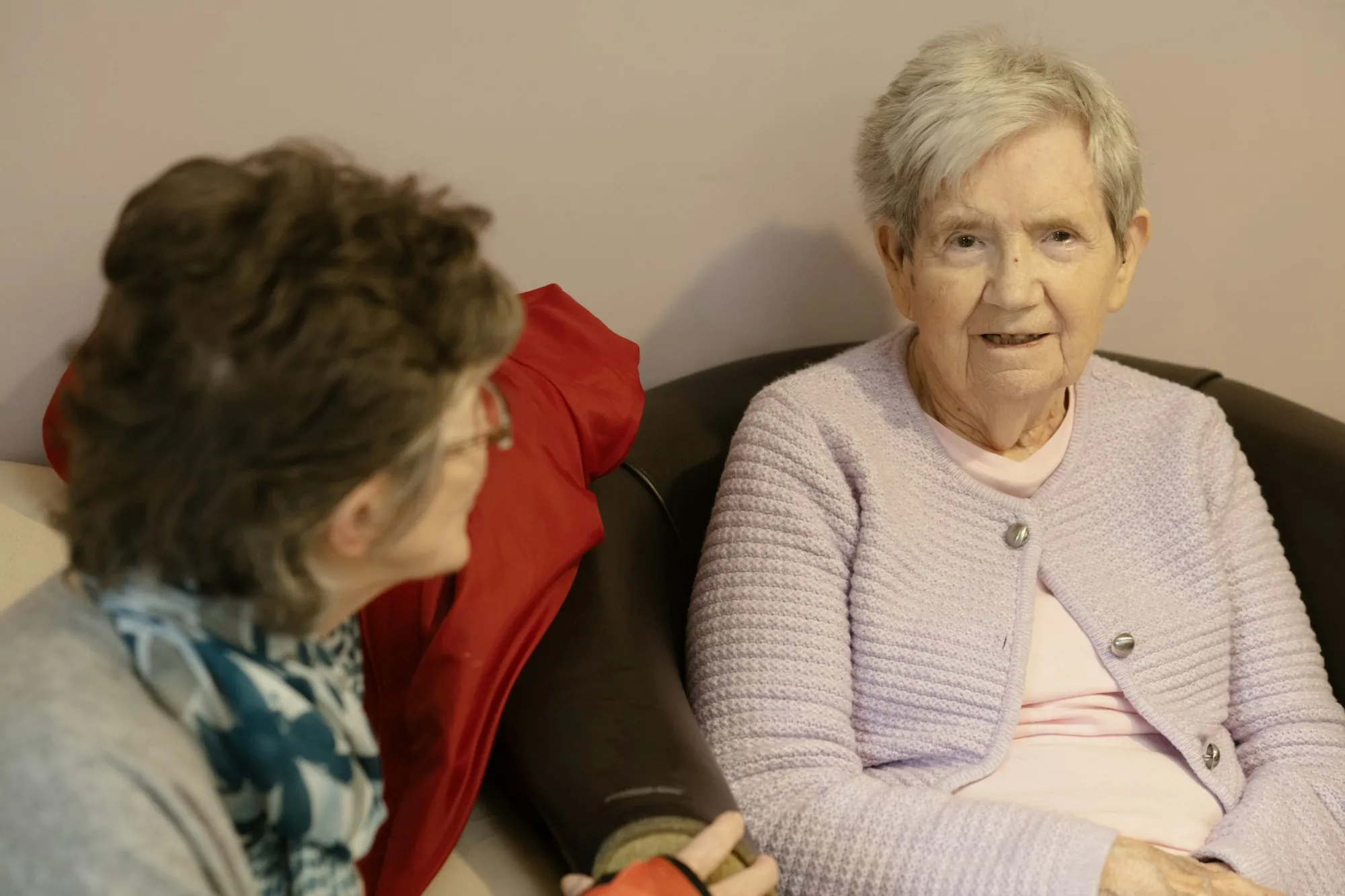 Two older women sitting and talking together